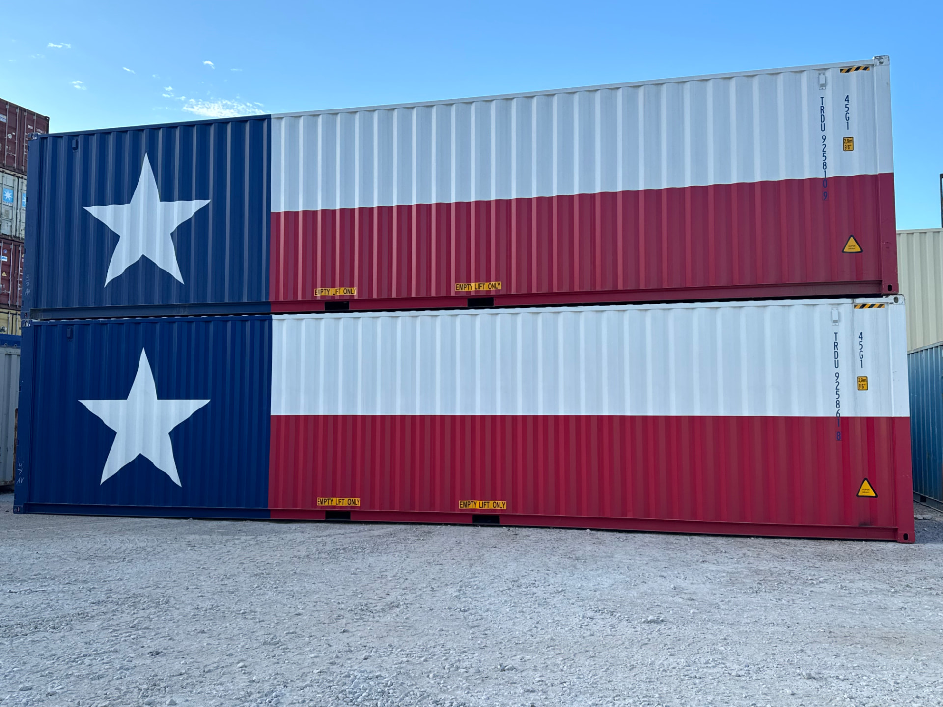 Two Texas flag painted shipping containers stacked at the TexCan yard